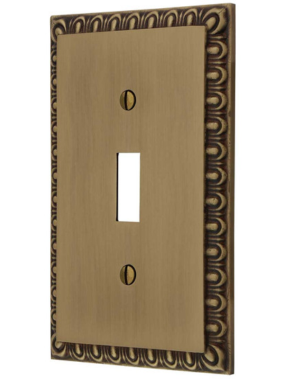 Ovolo Single Toggle Switch Plate in Antique Brass.